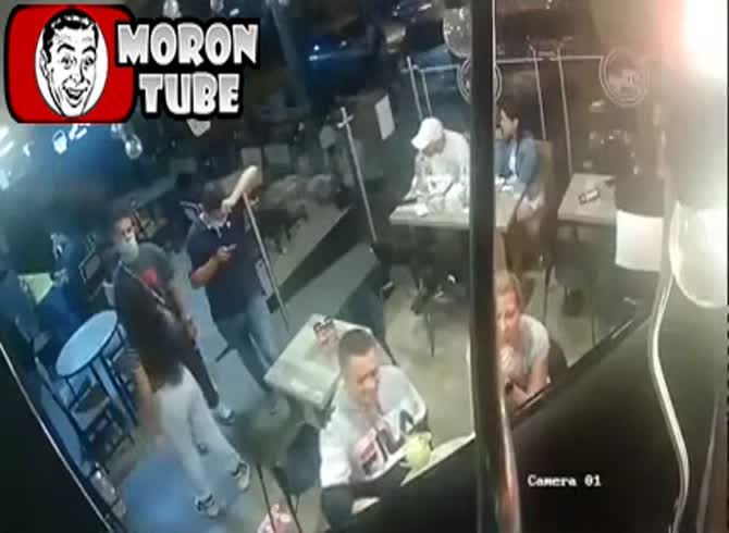 Video: A guy is pointing a pistol at his head while he keeps eating his chicken wings!